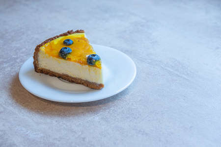 white plate with pie of homemade cake with berry decorate on top