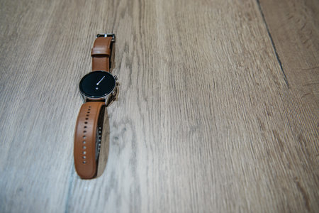 classic smart watch on a rustic table with space for textの写真素材