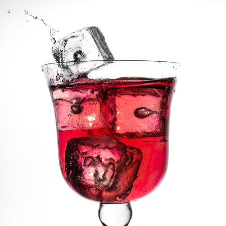fresh wine flowing in a glass with iceの写真素材