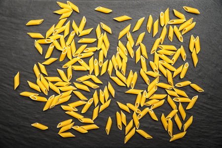 raw italian pasta on black backgroundの写真素材