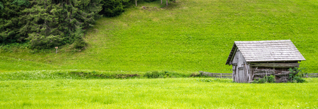 an old wooden hut in the mountainsの写真素材