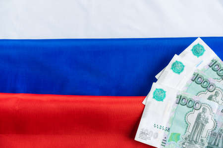 Russian ruble banknotes on russian flagの写真素材