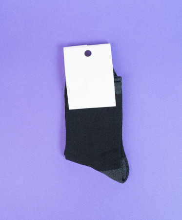 Socks on purple background. Socks with white label for your design. Mock upの写真素材