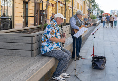 Russia, Nizhny Novgorod, August 25, 2024, Musicians play melody in the Bolshaya Pokrovskaya street. Senior musiciansのeditorial素材