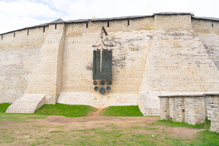 Pskov Kremlin. Dovmonts sword, shield and sword hang on the fortress wall of the Pskov Kremlin. High quality photoの写真素材