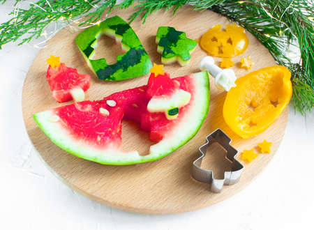 Slices of watermelon in the form of a Christmas tree. Creative ideas for Xmas, New Year's food. Healthy Christmas breakfast idea for kids or partyの写真素材