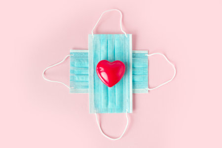 Valentines Day Medical face mask and red heart. . Coronavirus Valentine. Covid-19 Valentine. Valentines day concept care.の写真素材