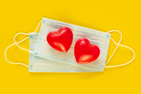 Valentines Day Medical face mask and red heart. Coronavirus Valentine. Covid-19 Valentine. Valentines day concept care. New normal for COVID 19.の写真素材