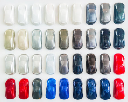 Paint samples when choosing a car color. Background palette for choosing the colors of the new car. Dealership acrylic small car figures many different colors.の写真素材