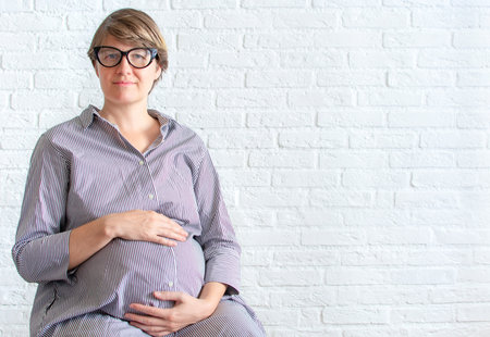 Young pregnant woman working concept planning shoppingの写真素材