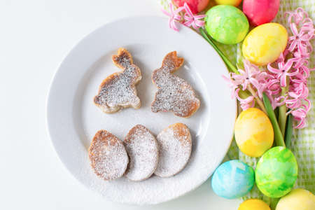 Easter still life composition breakfast. Easter eggs, egg pancakes and bunnies, pink hyacinth....