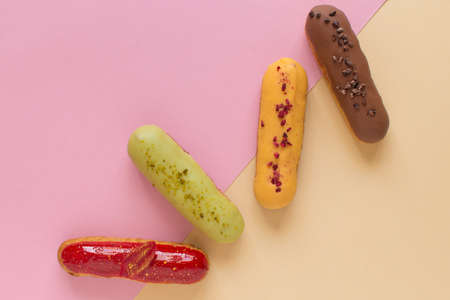 Eclairs on a minimal background. Still life hello dessert mood. Traditional French dessert with...