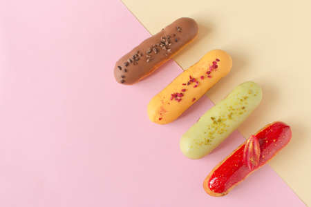 Eclairs on a minimal background. Still life hello dessert mood. Traditional French dessert with...