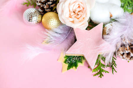 Christmas composition. Pink christmas gifts, fir branches and red berries. Christmas, new year concept, winter.の写真素材