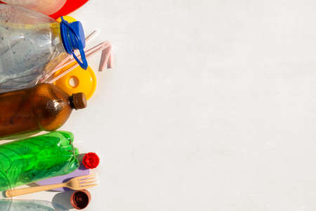 Recycling plastic. Reuse garbage, recycle, plastic free. Multi-colored plastic trash on a white background. Ecology concept. Copy space. Recycling plastic.の写真素材