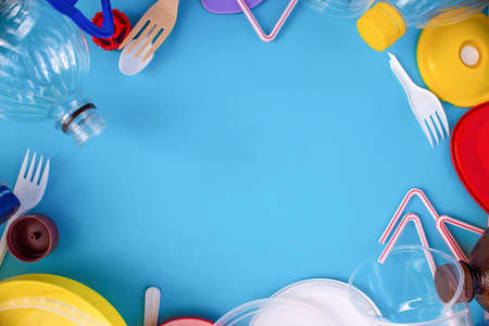 Reuse garbage, recycle, plastic free. Multicolored plastic trash on a blue background. Ecology...