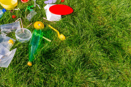 Reuse garbage, recycle, plastic free. Food plastic packaging, trash on green grass background....