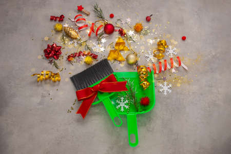 Christmas cleaning after. Cleaning brush and scoop, Christmas gold decorations after party Concept of cleaning after holiday clean up the messの写真素材