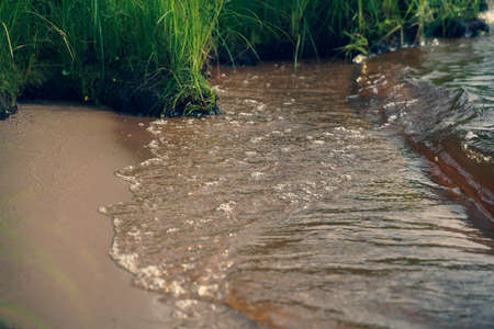 water flowing into the riverの写真素材
