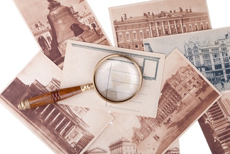 Pile of old cards with copyspace and magnifier isolated on white backgroundの写真素材