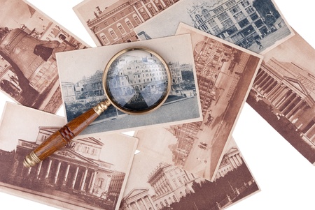 Pile of old cards with a magnifier isolated on white backgroundの写真素材