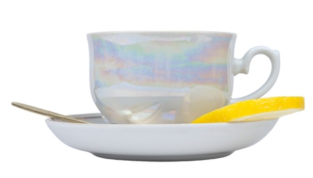 Cup of tea and sauser with lemon and spoon の写真素材