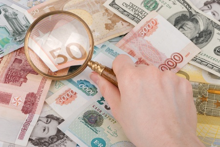 money and magnifier in hand enlarging banknote 