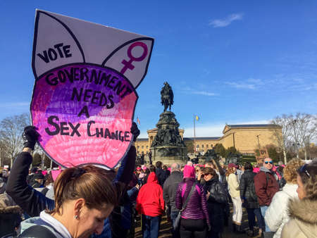 Woman holds "Government needs a sex change" sign at Women's March in Philadelphia, PA.のeditorial素材