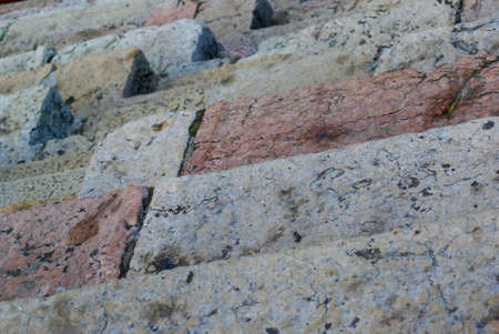 Abstract close up of ancient Roman arenas worn stone steps and seats.