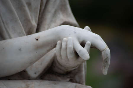 Stone sculpted hands of Jesus and Mary in a Victorian cemeteryの写真素材