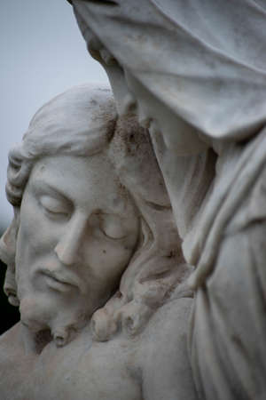 Close up of Jesuss face with eyes closed, Victorian cemetery statue.