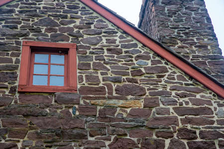 Closeup colonial American stone home exterior antique window chimneyの写真素材
