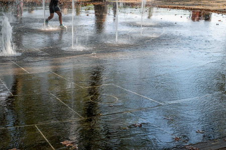 Child plays in the public fountain Battery Park New York Cityのeditorial素材