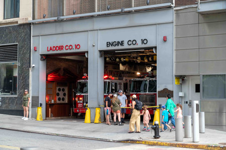 Fire Engine lights flash in FDNY NYC Fire Station doors open onlookersのeditorial素材
