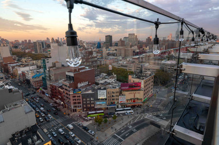 String of festive lights on NYC rooftop terrace sprawling cityscape