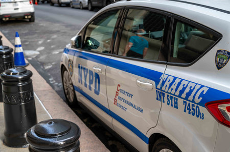 Closeup side view of NYPD traffic police car on city street blue coneのeditorial素材