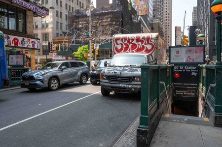 NYC 50th St subway entrance with cars and truck covered in street artのeditorial素材