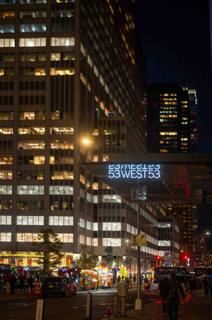 53 West 53 building sign on NYC nighttime street with food trucksのeditorial素材