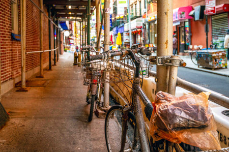 Two vintage weathered old bicycles with baskets urban scaffoldingのeditorial素材