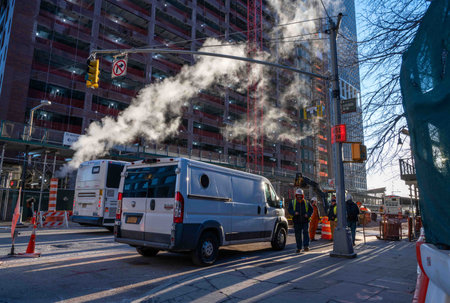 Construction zone with workers on busy NYC street with steam ventingのeditorial素材