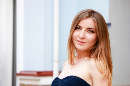 beautiful blonde woman in prom dress in the cityの写真素材