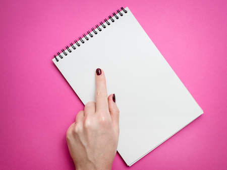 Design concept - Top view of mans hand holding hardcover gray linen notebook and ballpoint pen isolated on white background for mockupの写真素材
