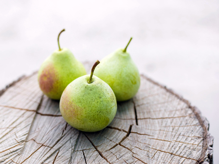 Harvesting. A fresh ripe pears of the original form lies on a stump on a natural background.の写真素材