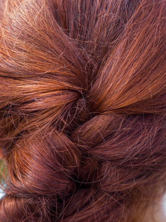 Bright background of red human female hair. The texture of human hair. Hairstyles.の写真素材