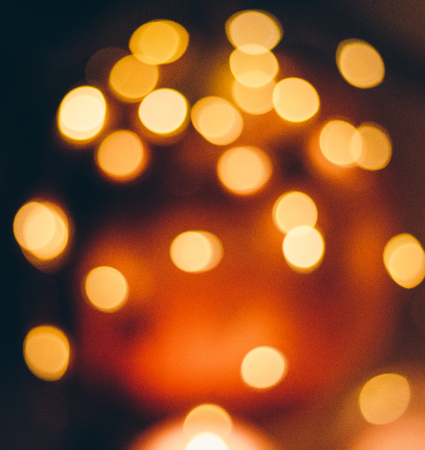 image of blurred bokeh background with warm colorful lights, vintage tone