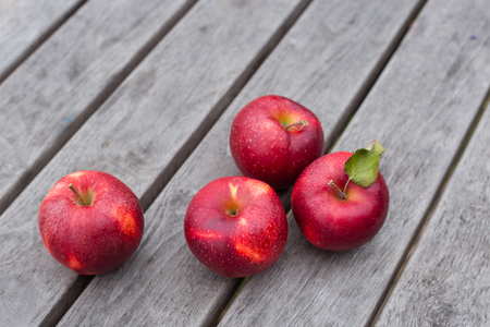 Organic fresh apples on wooden background. Agriculture concept theme with fresh apples in natureの写真素材