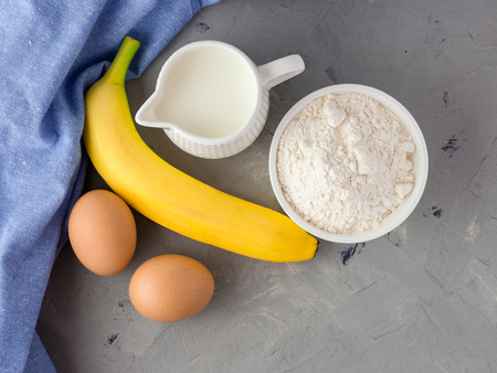 The ingredients for the banana cake on gray backgroundの写真素材