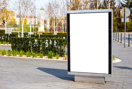 Vertical small billboard in the city on the sidewalk. Mock up for advertising or announcementsの写真素材
