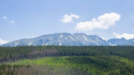 Mountain range with visible silhouettes. Standing empty on top of a mountain view. Trekking and tourism concept. High mountain landscapes. natural outdoor travel background. Beauty world.の写真素材