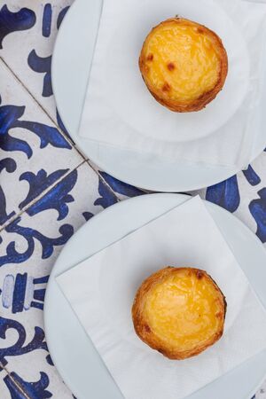 Egg tart, traditional Portuguese dessert pastel de nata on Blue textile background. Top view.の写真素材